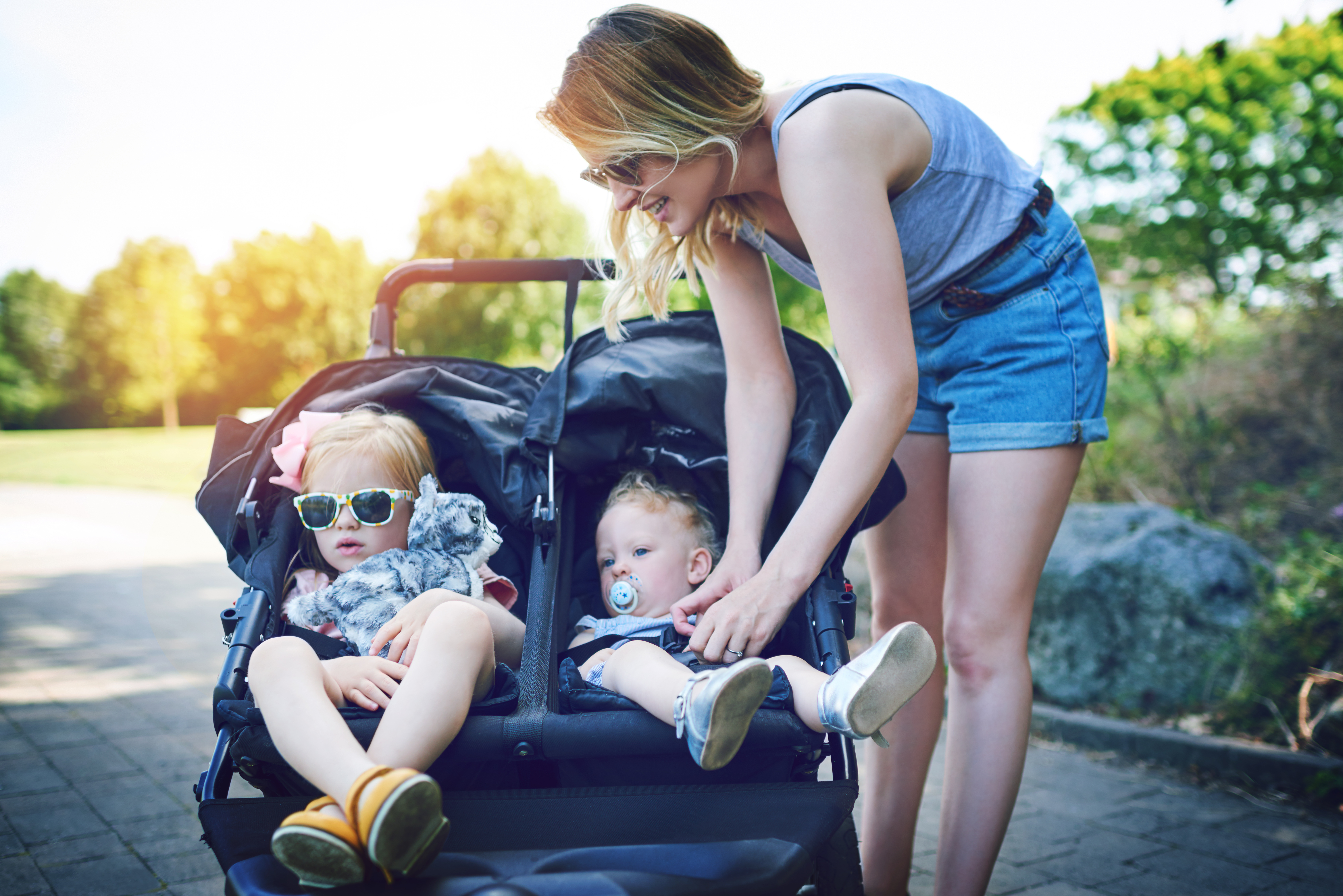Family strolling in the park with Happy Feet stroller